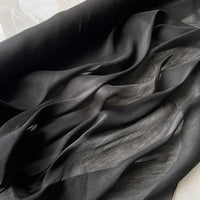 Gros plan sur Tissu soie et lin 14 mommes de Longan Craft France, un organza de soie de mûrier semi-transparent aux plis souples et fluides et à la texture lumineuse, idéal pour l'été avec sa légèreté luxueuse et sa couleur vibrante.