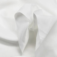 Gros plan sur Microsuède polyester multicolore au mètre de Longan Craft France, qui présente une texture peau de pêche brossée avec des plis doux et des ombres légères - un tissu doux idéal pour vêtements et décoration.