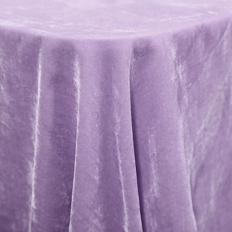 Une table ronde est drapée de Velours de soie de mûrier doux de Longan Craft France, un velours d'ameublement doux à base de soie et de rayonne, parfait pour l'ameublement, la couture et l'artisanat, présenté ici dans une gracieuse nuance violet clair.