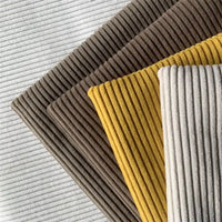 Quatre pièces de Tissu côtelé polyester 4,5 côtes au mètre de Longan Craft France en blanc, marron, jaune et gris sont disposées en diagonale - idéal pour les pantalons ou les projets de décoration intérieure.