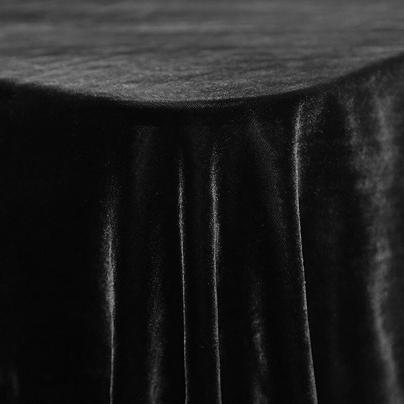 Gros plan sur le Velours de soie de mûrier doux de Longan Craft France - un tissu d'ameublement en velours de soie-rayon doux - drapé sur une table, mettant en valeur la surface lisse et les plis doux, idéal pour les meubles ou les projets de couture créatifs.