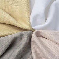 Quatre pièces de Tissu piqué nid d'abeille au mètre de Longan Craft France en beige, blanc, gris et rose pâle sont disposées en cercle avec des centres qui se chevauchent. Ce tissu 100 % polyester présente un tissage diagonal subtil, idéal pour les projets de bricolage de vêtements de sport.