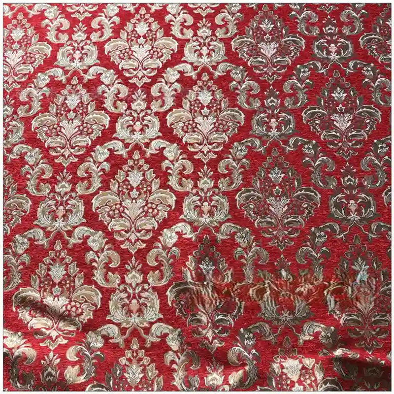 Un gros plan du tissu damassé chenille au mètre de Longan Craft France montre de luxueux motifs floraux jacquard en or et en argent, avec une texture légèrement surélevée et de douces rides qui mettent en valeur son élégant design de tapisserie damassée.