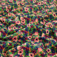 Gros plan sur le "Tissu velours côtelé à fleurs colorées au mètre" de Longan Craft France, qui présente un motif floral ridé dans des tons vibrants de vert, rose, orange, bleu et jaune - idéal pour la confection, l'ameublement et les loisirs créatifs.