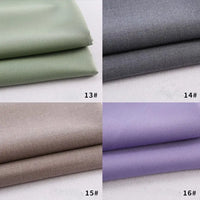 Quatre échantillons de gabardine de Longan Craft France - vert clair (13#), gris (14#), beige (15#) et violet clair (16#) - sont pliés sur une surface blanche, chacun étant fabriqué à partir d'un polyester-rayon épais, idéal pour les uniformes de bricolage.