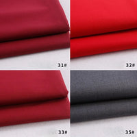 Quatre échantillons de Tissu gabardine polyester rayonne de Longan Craft France sont présentés : rouge foncé (31#), rouge vif (32#), bordeaux (33#) et gris (35#). Chaque échantillon plié repose sur un fond blanc. Parfait pour le bricolage d'uniformes.