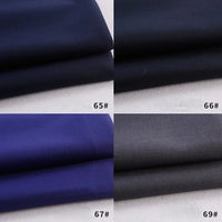 Quatre piles de tissu Longan Craft France gabardine polyester-rayon dans les tons bleu et gris (65#, 66#, 67#, 69#), disposées en grille, parfaites pour les uniformes et les projets de bricolage.