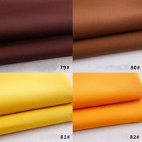 Quatre échantillons de gabardine Longan Craft France pliés - 79#, 80#, 81# et 82# - en brun foncé, brun moyen, jaune vif et orange sont disposés dans une grille. Textile polyester-rayon parfait pour les uniformes ou les projets de bricolage.