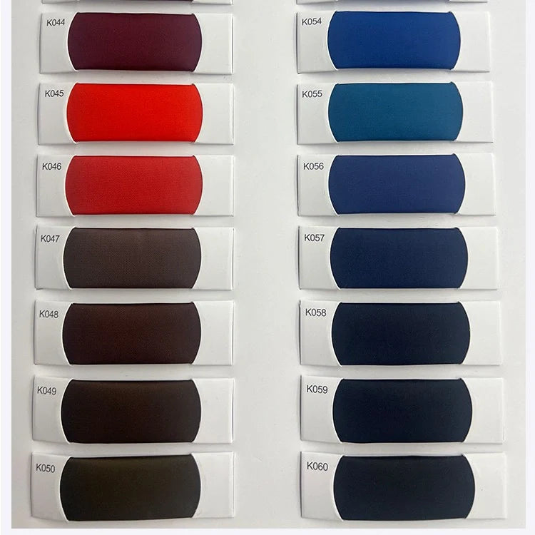 Douze échantillons rectangulaires (K044-K060) du tissu satiné coloré en viscose au mètre de Longan Craft France sont disposés en deux colonnes, présentant des nuances de rouge, de brun, de bleu et de gris foncé, idéales pour les robes élégantes.