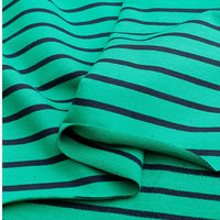 Gros plan sur le Tissu French Terry extensible rayé coloré au mètre de Longan Craft France, un tricot de coton doux à rayures noires, légèrement froissé, idéal pour des sweat-shirts confortables.