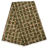 Un morceau de Tissu wax africain Ankara coloré au mètre de Longan Craft France présente des tourbillons verts et bruns vibrants sur fond blanc, avec des bords visibles sur un fond blanc - parfait pour les styles vestimentaires à la mode.