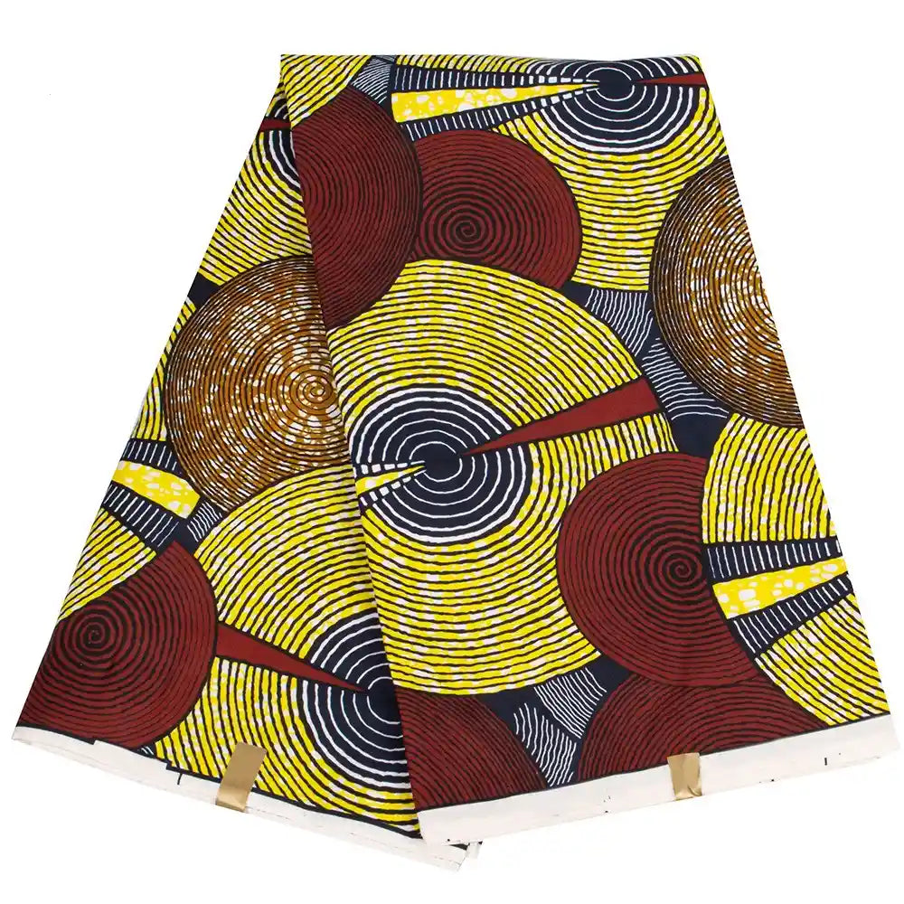 Le Longan Craft France Tissu wax africain Ankara coloré au mètre présente un motif vibrant de cercles concentriques jaunes, rouges, noirs et blancs avec des lignes diagonales, parfait pour divers styles vestimentaires.