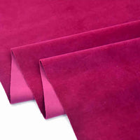 Trois feuilles de Longan Craft France Velours de coton 100% pur au mètre, un tissu velours de coton uni doux et lisse pour la couture et l'artisanat, sont partiellement pliées sur un fond blanc avec des bords nets et précis.