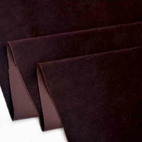 Trois feuilles de Longan Craft France Velours de coton 100% pur au mètre, un doux tissu velours uni pour couture et ameublement, sont superposées avec des bords bouclés se chevauchant sur un fond blanc.