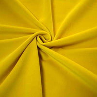 Gros plan sur Longan Craft France Velours de coton 100 % pur au mètre, un tissu de velours de coton doux et jaune vif, froncé et tordu au centre pour créer des plis lisses rayonnant vers l'extérieur dans un motif en spirale.