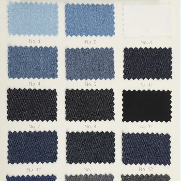 Une grille de 12 échantillons de Tissu sergé de viscose coloris denim de Longan Craft France, allant des teintes claires aux teintes foncées-matière extensible idéale pour la confection de vêtements créatifs ou vestes chic.