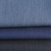 Trois pièces pliées de Longan Craft France tissu sergé de viscose coloris denim au mètre, montrant différentes nuances-un textile chic et extensible avec élasthanne, parfait pour la confection de vêtements élégants et durables.