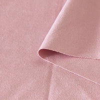 Gros plan sur le tissu suédine double face au mètre de Longan Craft France, un tissu microfibre imitant le daim pour les housses de canapé, les sacs et les doublures, montrant sa surface légèrement texturée et un pli visible sur l'un des bords.