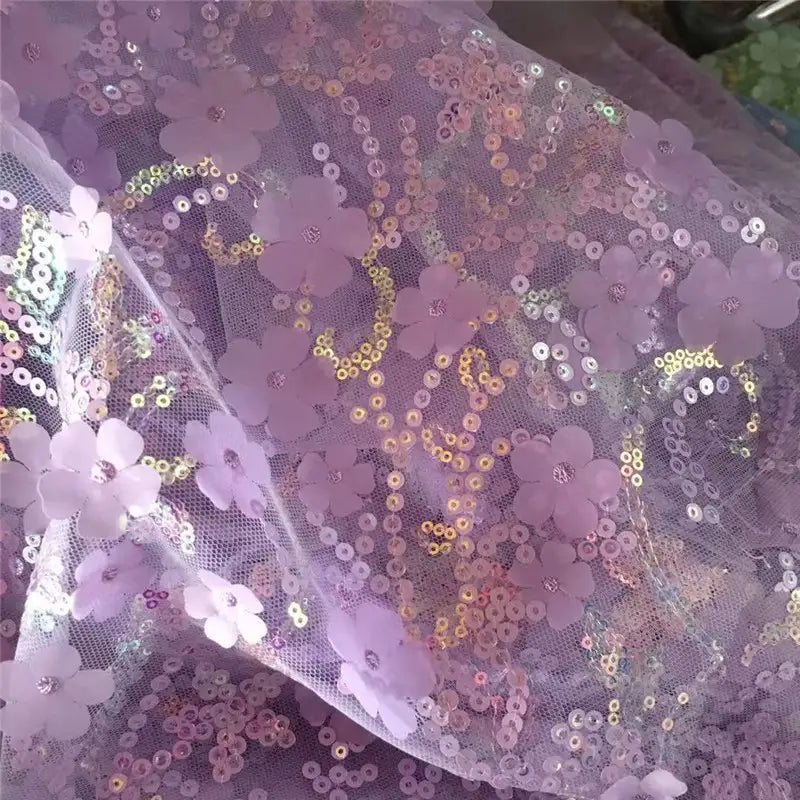 Gros plan sur le Tissu sequin floral au mètre de Longan Craft France : résille lavande transparente avec des fleurs en paillettes en relief et des broderies irisées, parfaite pour les robes décoratives ou les accessoires.