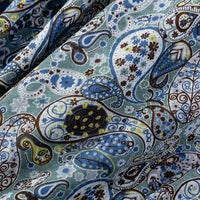 Gros plan sur Tissu jersey imprimé paisley au mètre by Longan Craft France-jersey 100% coton à motifs bleu, vert, blanc et brun avec détails floraux, idéal pour chemisiers et vêtements.