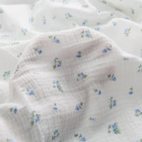 Double gaze de coton à fleurs bleues au mètre