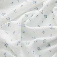 Double gaze de coton à fleurs bleues au mètre