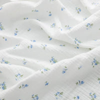 Double gaze de coton à fleurs bleues au mètre