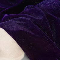 Gros plan sur le tissu velours pailleté au mètre de Longan Craft France, un doux velours polyester argenté à paillettes scintillantes, idéal pour décoration, robes de soirée et projets DIY couture. Une surface claire apparaît en bas à gauche.