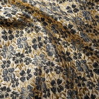 Tissu brocart doré à motifs floraux embossés au mètre