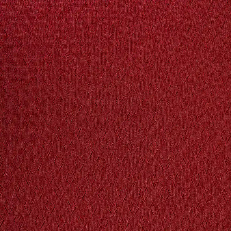 Un gros plan du Tissu pointelle cœur au mètre de Longan Craft France montre son subtil motif de losanges répétitifs. Ce tissu extensible de haute qualité est parfait pour les couches de base DIY et les vêtements d'intérieur alliant confort et style.