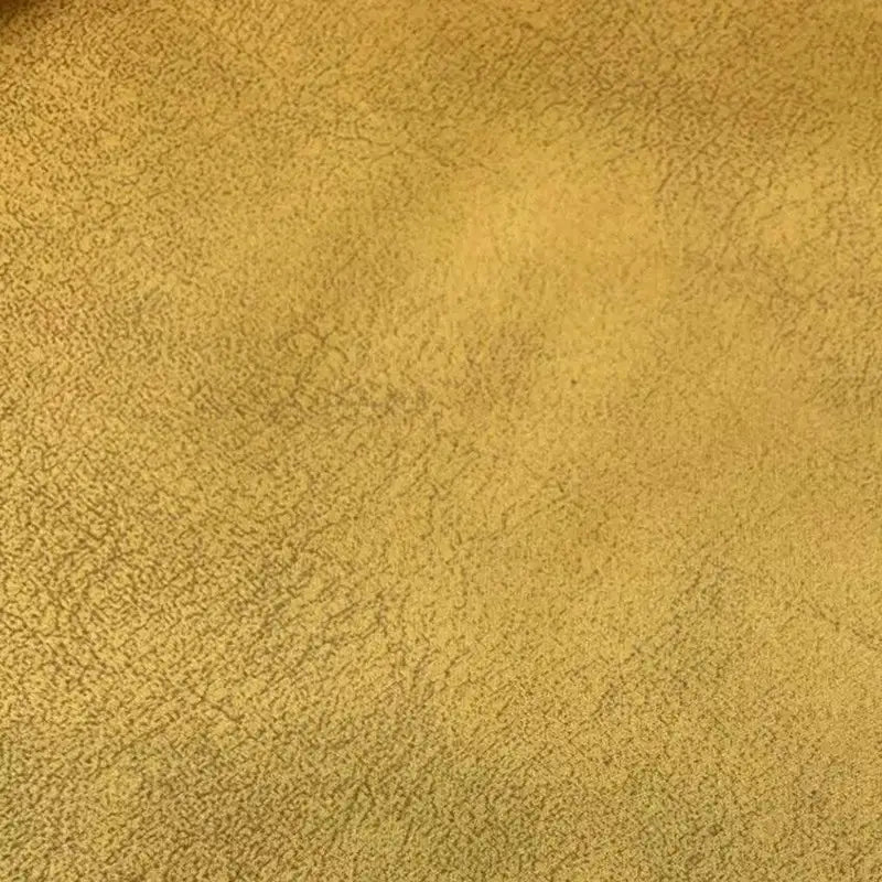 Gros plan sur le tissu suédine au mètre de Longon Craft France, qui présente un motif de litchi et une texture veloutée dans des tons brun-jaune, idéal pour le bricolage, les manteaux ou l'habillage des canapés.