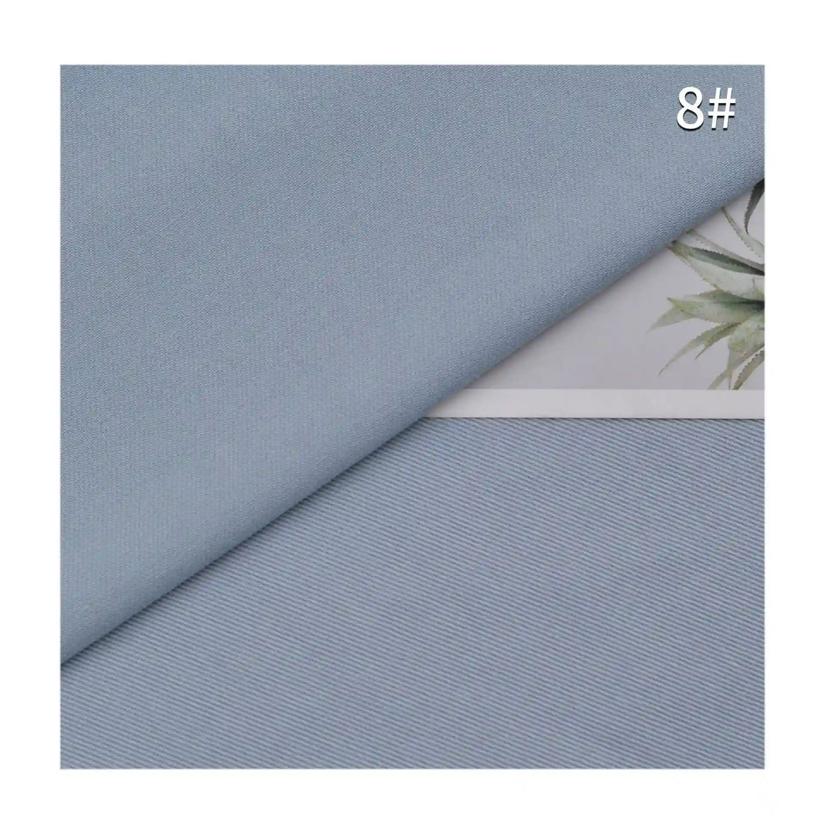 Un échantillon de Tissu lyocell mélangé coton bambou multicolore au mètre de Longan Craft France est présenté en diagonale, recouvrant partiellement une feuille avec une image de plante. Le chiffre "8#" apparaît dans le coin supérieur droit.