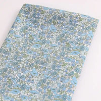Tissu léger en coton linon de Longan Craft France, présentant un imprimé floral multicolore sur un fond clair - idéal pour les vêtements d'été. Disponible au mètre.