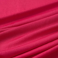 Gros plan sur le tissu Longan Craft France jersey polyester multicolore au mètre, montrant ses plis lisses et légèrement brillants et son tissage visible. Ce jersey polyester-élasthanne est doux, extensible et idéal pour la confection de robes.