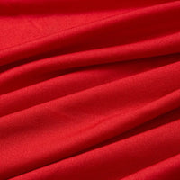 Le Tissu jersey polyester multicolore au mètre de Longan Craft France est présenté en gros plan. Il présente des plis doux et une surface extensible légèrement brillante, idéale pour les peignoirs.