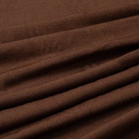 Un gros plan du Tissu jersey polyester multicolore au mètre de Longan Craft France montre sa surface texturée et ses plis horizontaux - parfait comme tissu jersey polyester-élasthanne pour les robes.