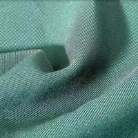 Gros plan sur le Tissu gabardine stretch multicolore au mètre de Longan Craft France, montrant sa texture de viscose tissée bleu-vert clair avec des stries diagonales visibles - parfait pour les costumes ajustés et les uniformes sur mesure.