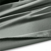 Gros plan sur le tissu en satin multicolore au mètre de Longan Craft France - un tissu en polyester brillant à bord brut, posé à plat sur du blanc - idéal pour créer des vêtements élégants.