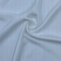 Gros plan sur le Satin de viscose multicolore de Longan Craft France, un tissu 100 % viscose qui présente des plis lisses et souples partant du centre - un choix élégant pour les robes du soir.