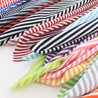Découvrez le tissu jersey coton rayé multicolore au mètre de Longan Craft France, une matière extensible idéale pour créer des vêtements de sport ou décors colorés grâce à ses rayures rouge, noir, violet, vert, bleu, jaune et rose.