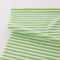 The Tissu jersey coton rayé multicolore de Longan Craft France, un jersey coton élasthanne extensible pour vêtements de sport, est présenté à plat sur une surface claire avec une section légèrement pliée.