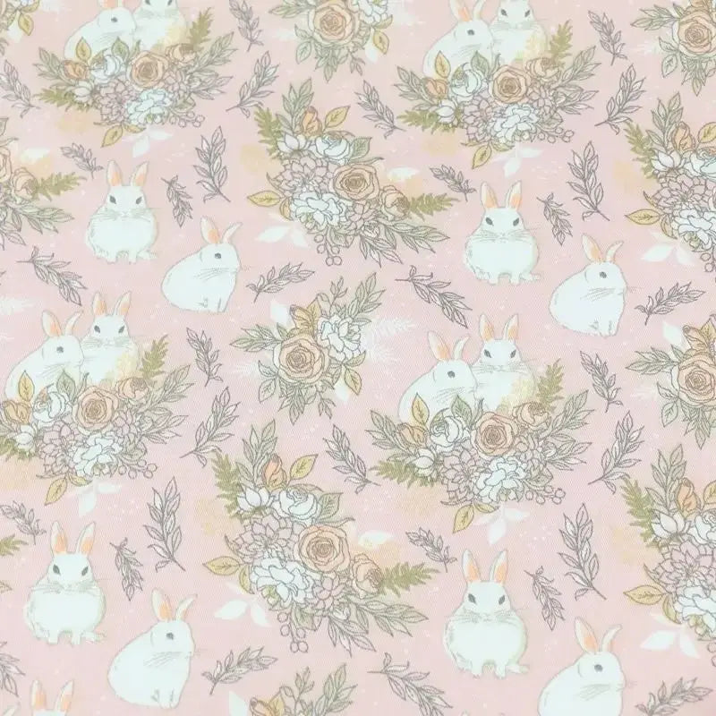 Le tissu lapin de Pâques rose et bleu au mètre de Longan Craft France, 100% coton, présente des motifs de lapins et fleurs pastel, idéal pour vos projets DIY printaniers et déco de saison.