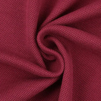Gros plan sur le tissu piqué motif œil d'oiseau à fil simple de Longan Craft France, un tissu respirant et texturé de couleur rouge foncé, disposé en spirale pour montrer sa trame - idéal pour les polos et T-shirts d'été DIY.