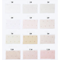 Douze échantillons de tissu rectangulaires étiquetés 1#-12#, disposés en trois rangées de quatre, présentent le Tissu en satin jacquard à petits pois de Longan Craft France, un tissu de satin confortable à pois multicolores destiné à l'habillement.