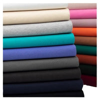 Une pile verticale de Tissu French Terry en coton uni au mètre de Longan Craft France présente des teintes neutres, bleues, vertes, violettes, orange et roses, idéales pour confectionner des sweatshirts avec du tissu French Terry de qualité supérieure.