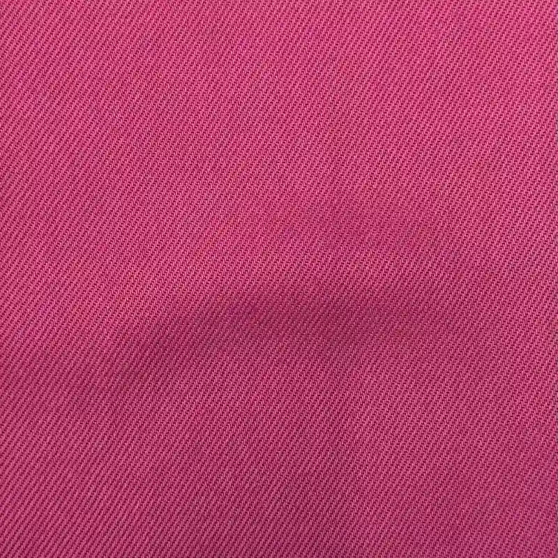 Gros plan sur le Tissu en lyocell denim multicolore au mètre de Longan Craft France, qui présente un tissage diagonal rose et une surface lisse et légèrement froissée. Ce denim sergé lyocell, respirant et confortable, est idéal pour les jeans et se vend au mètre.