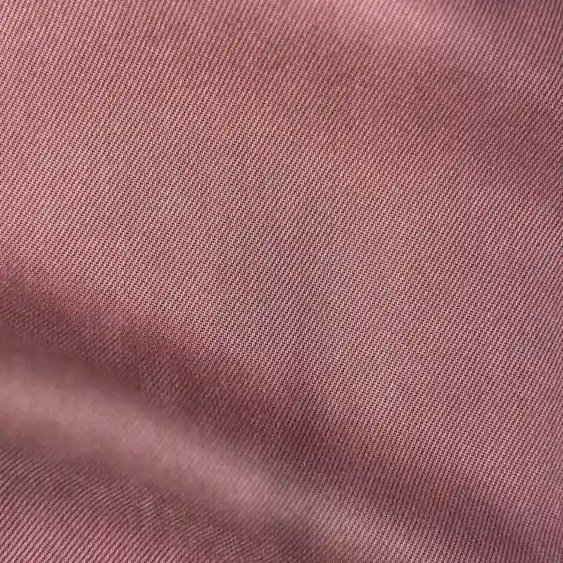 Gros plan sur le tissu en lyocell denim multicolore au mètre de Longan Craft France, montrant sa fine trame sergée diagonale et ses plis subtils - un textile en lyocell respirant et confortable pour les jeans.