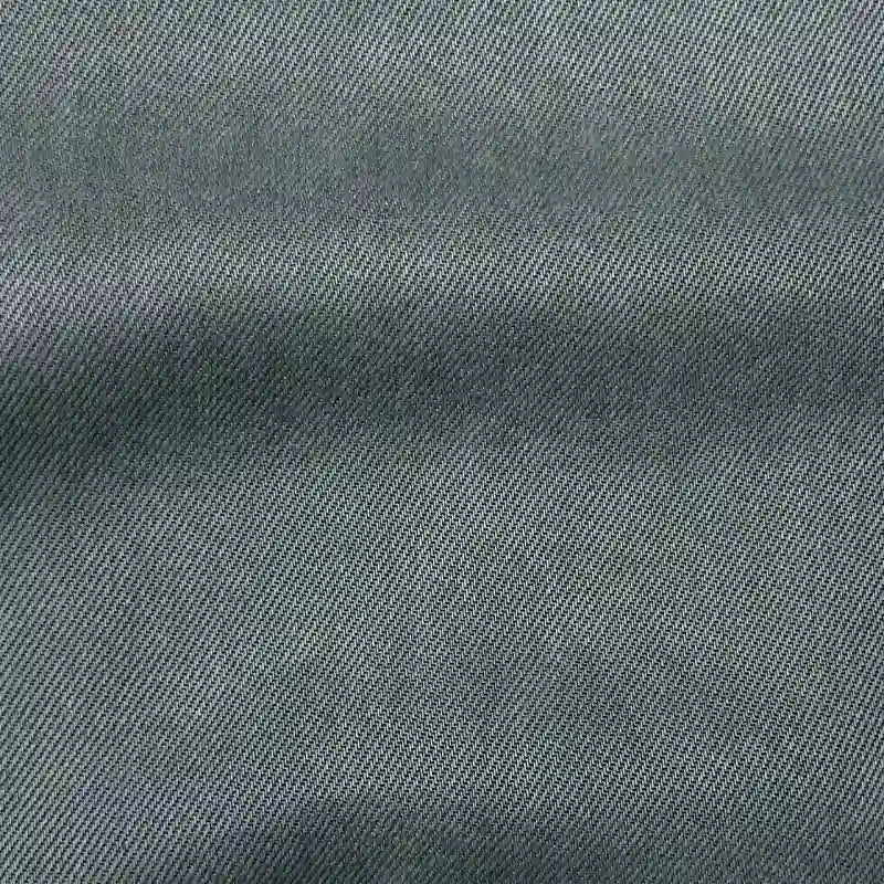 Gros plan sur le tissu en lyocell denim multicolore au mètre de Longan Craft France, qui présente un tissage sergé texturé et un ombrage subtil. Ce textile lyocell est respirant, confortable et idéal pour les jeans durables.
