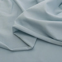 Le Jersey coton élasthanne au mètre de Longan Craft France est un tissu lisse, doux et extensible idéal pour la confection de robes. Il se caractérise par sa couleur bleu clair et son aspect légèrement drapé.