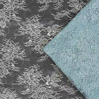 Gros plan sur deux pièces de Tissu dentelle pailleté avec sequins au mètre de Longan Craft France - l'une noire avec des fleurs blanches, l'autre bleu clair - dentelle de qualité idéale pour les peignoirs, la lingerie ou les projets créatifs.